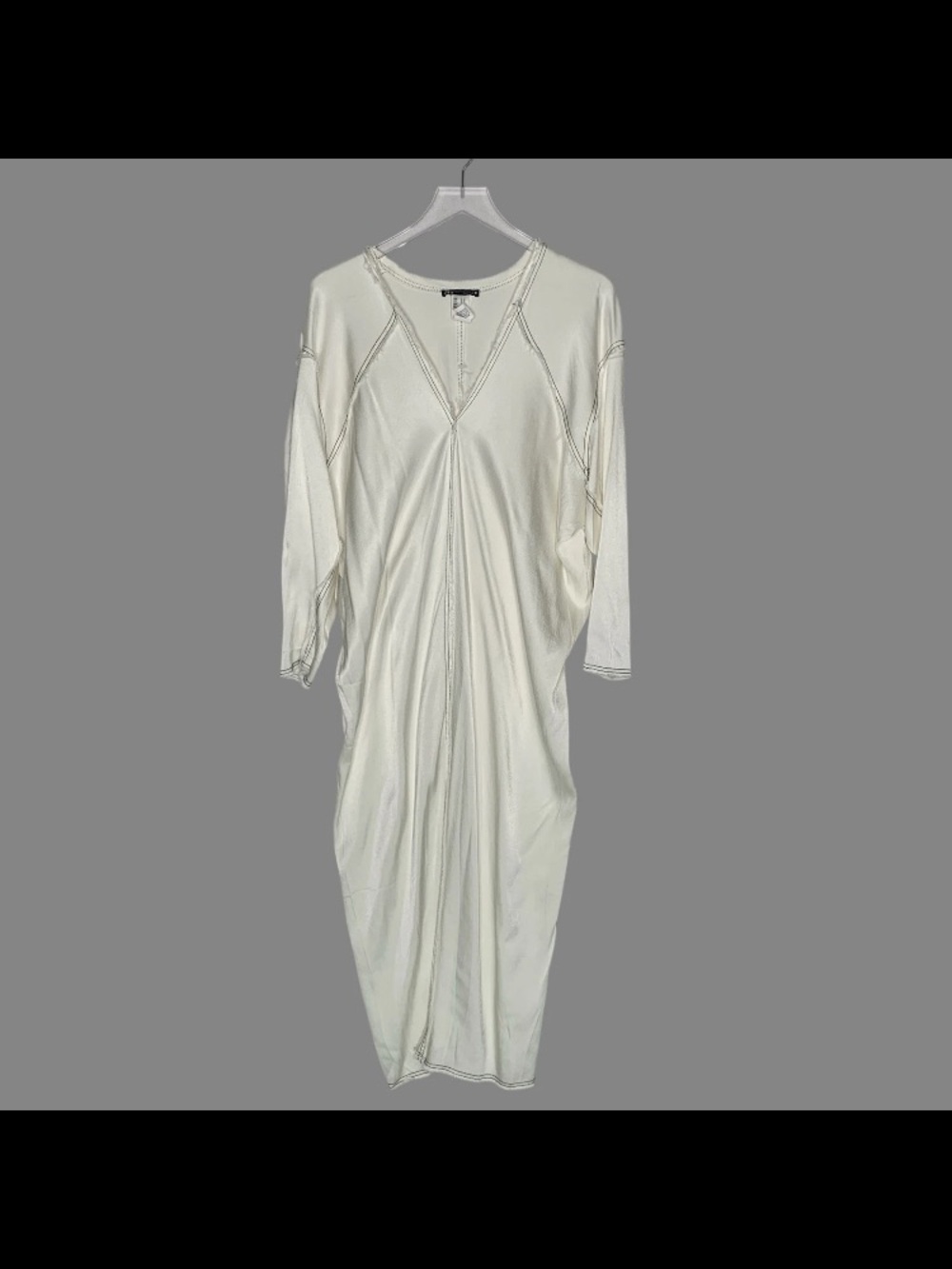 Satin effect kaftan style.The frayed finish along the entire hem and neck